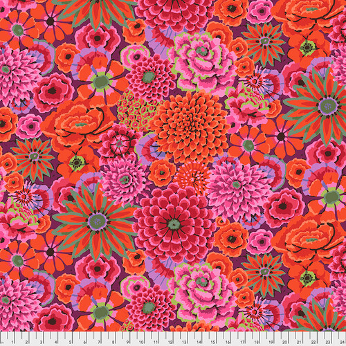 Fabric featuring vibrant pink, red, and purple flowers over a deep violet background