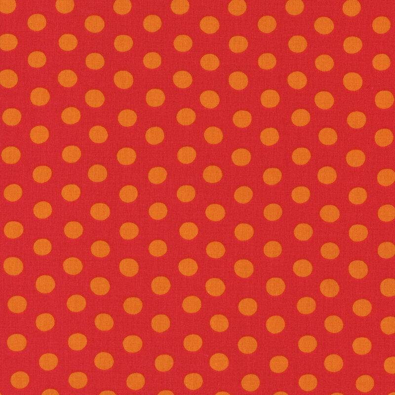 Fabric featuring vibrant orange polka dots over a crimson orange background