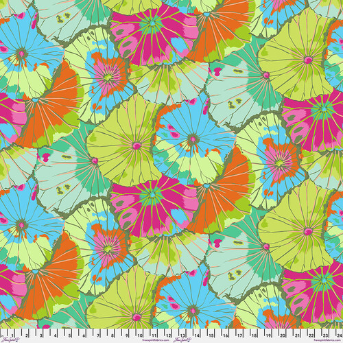 close up of Fabric featuring vibrant green, blue, magenta, and orange overlapping lotus leaves
