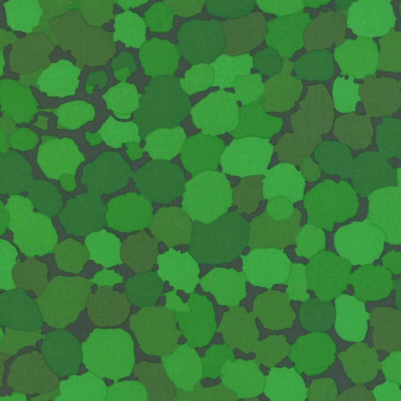 Fabric features vibrant green abstract dots over a deep forest green background