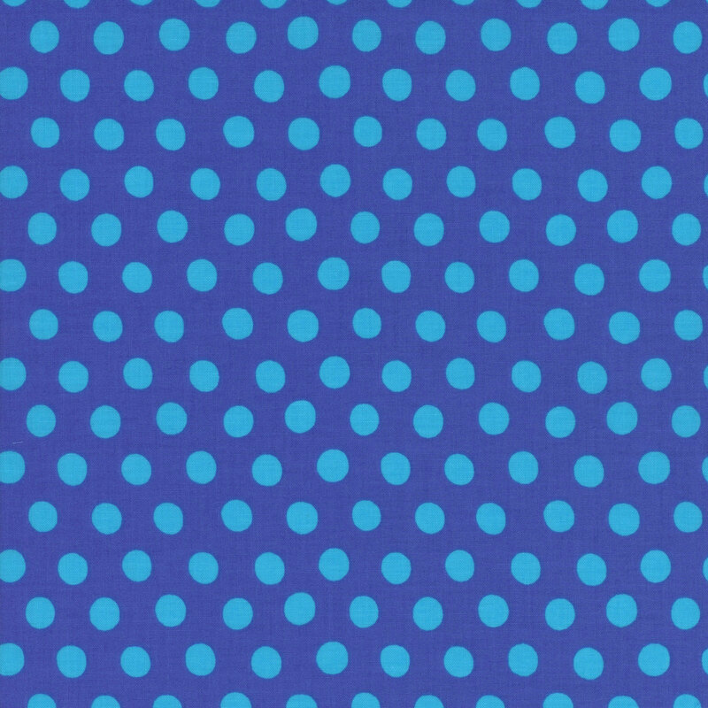 Fabric featuring vibrant teal polka dots over a royal blue background