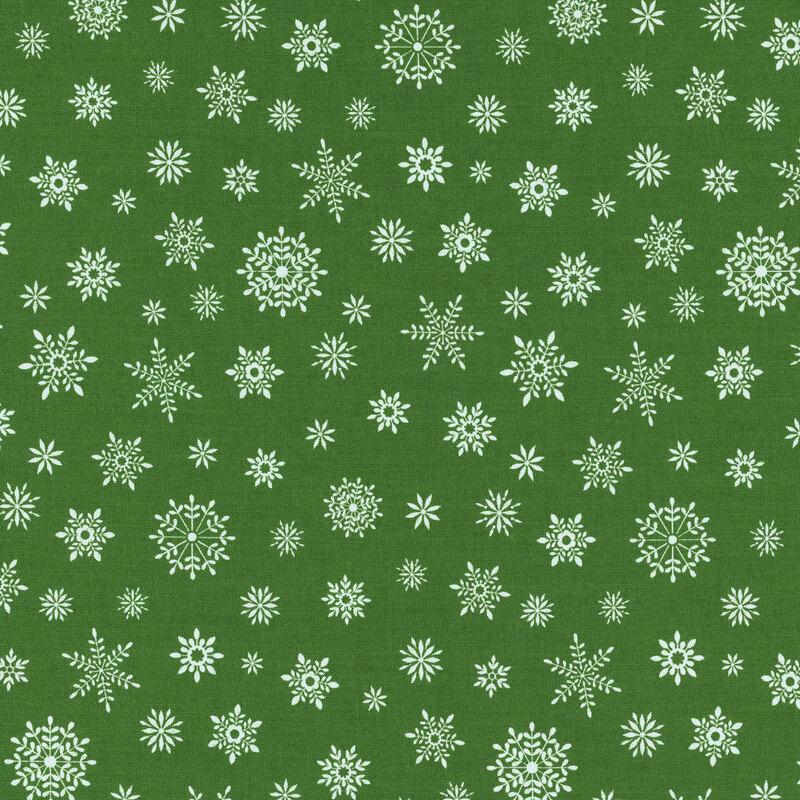 Small white snowflakes on a festive green fabric.