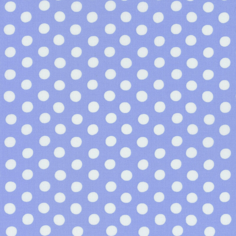 Fabric featuring white polka dots over a periwinkle blue background