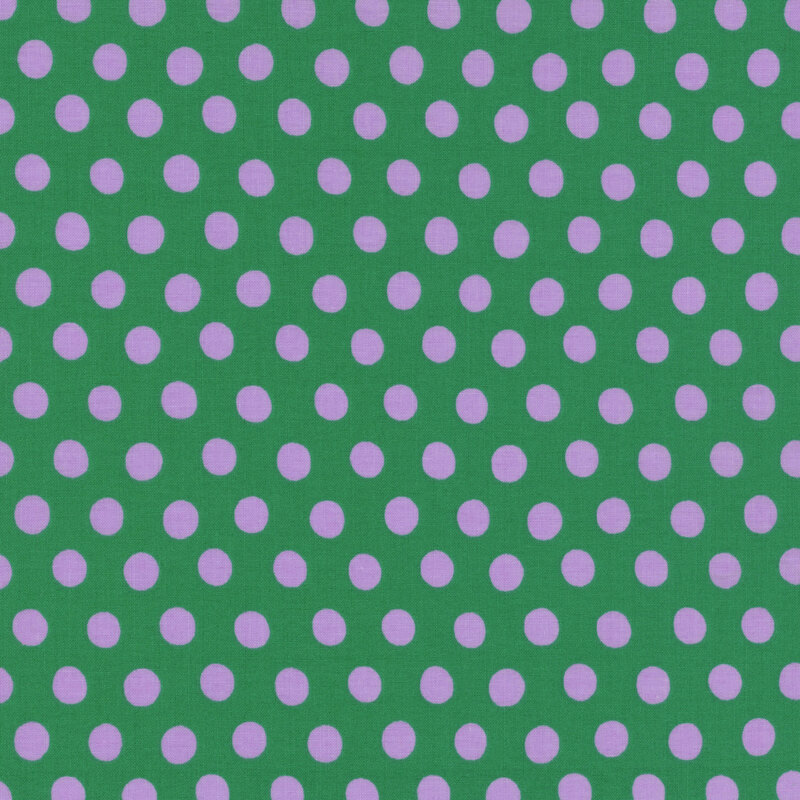 Fabric featuring vibrant lilac polka dots over a teal background