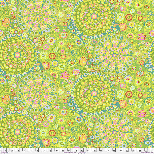 Fabric featuring vibrant green, teal, orange, and pink kaleidoscopic abstract shapes
