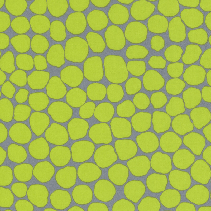 Fabric featuring vibrant lime green abstract dots over a dark teal background