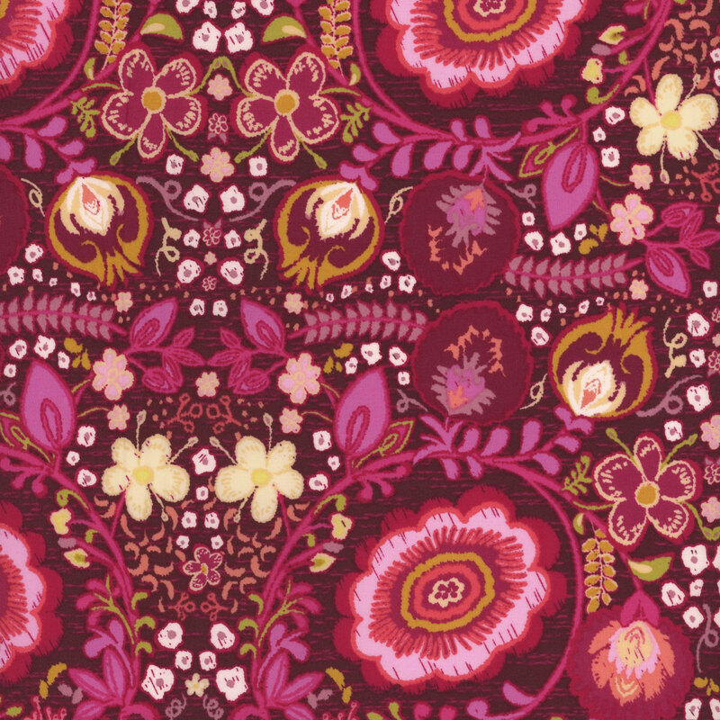 fabric with a gorgeous kaleidoscopic floral design in rich burgundy, magenta, pink, peach, and orange