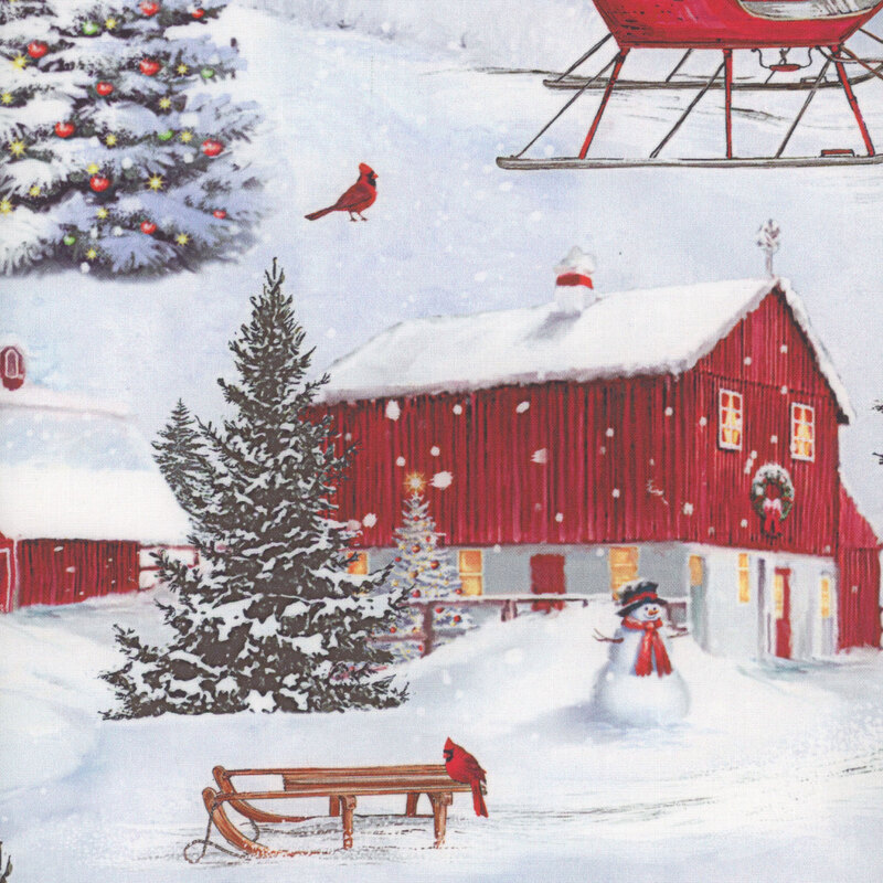 Fabric with a snowy scene of red barns, cardinals and sleds, snowmen, and Christmas trees.