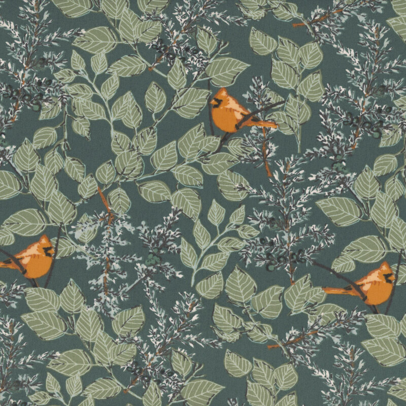 Dark green fabric featuring gray and green juniper and deciduous tree boughs filled with leaves and featuring small red cardinals