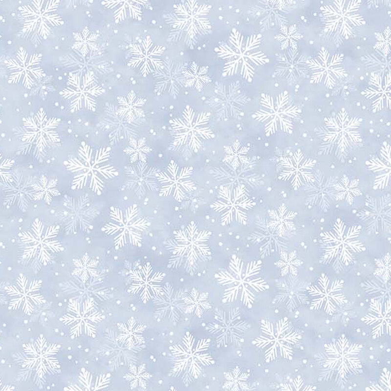 White snowflakes against a pastel blue mottled fabric.