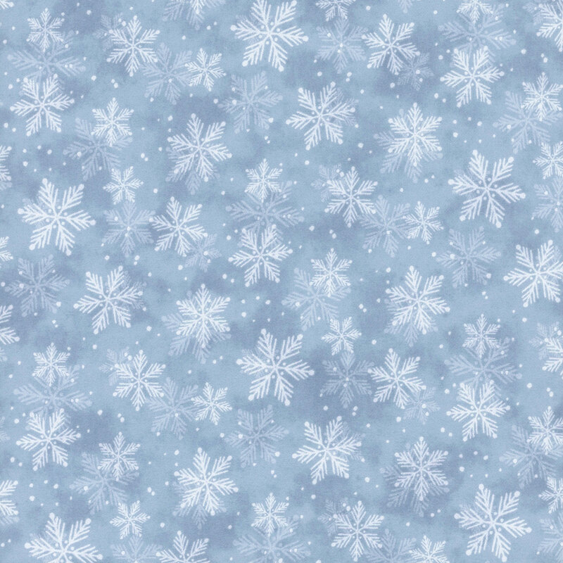 White snowflakes against a blue mottled fabric.