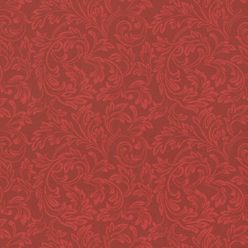 Red fabric with tonal scrolls in swirling leaf patterns.