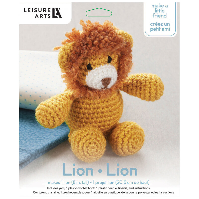 Front of the kit, showing the complete crocheted lion staged in front of folded fabric