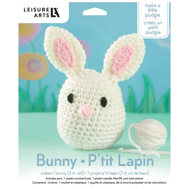Front of the kit, showing the complete crocheted bunny staged in front of a spring themed  backdrop