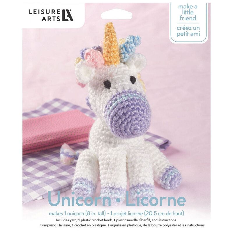 Front of the kit, showing the complete crocheted unicorn staged in front of coordinating, folded up fabric