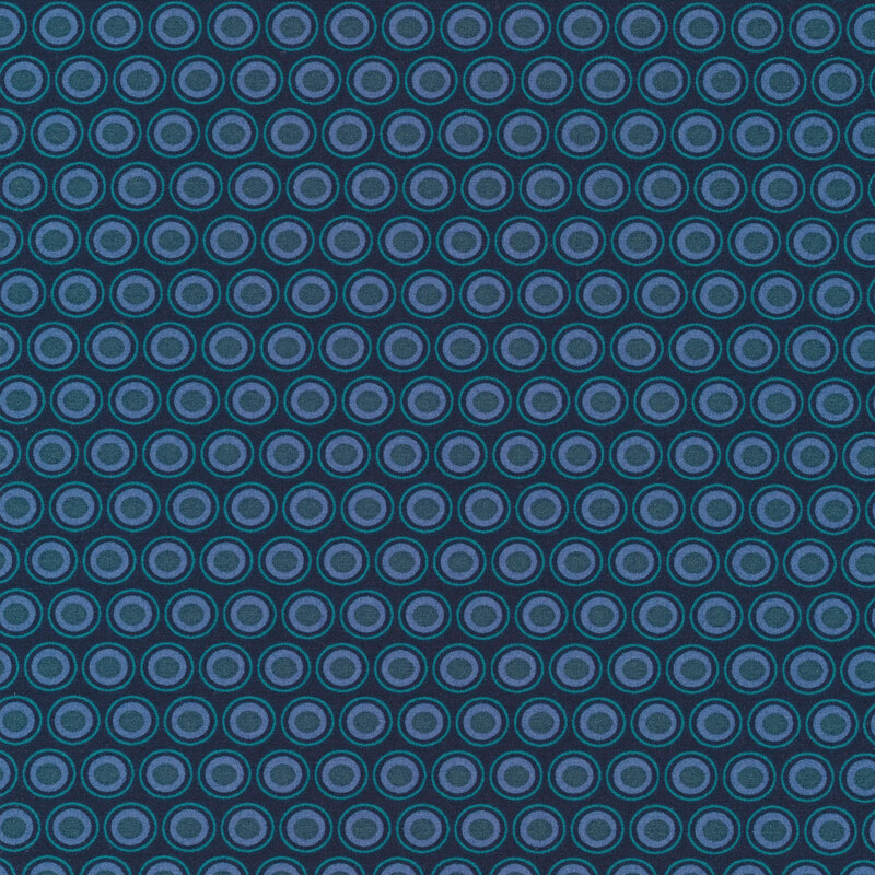 dark indigo fabric with a lovely light blue and teal oval polka dot design