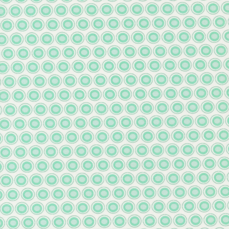 White fabric with an aqua and white oval polka dot design