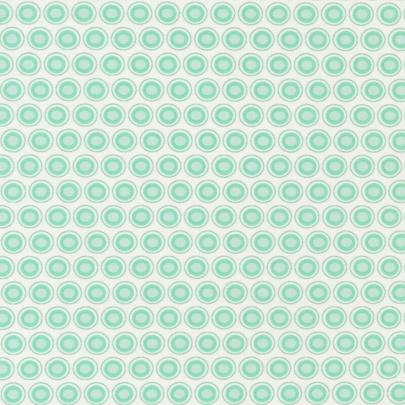 White fabric with an aqua and white oval polka dot design