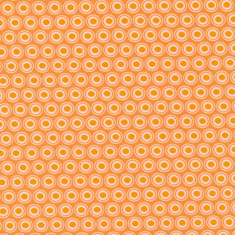 peach fabric with a lovely white and bright orange oval polka dot design