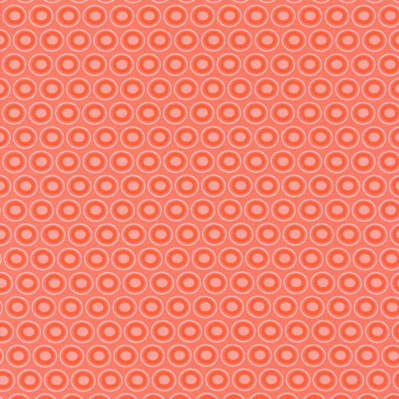Coral fabric with a lovely dark coral and peach colored oval polka dot design