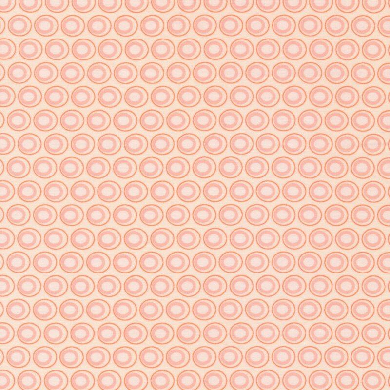 Pastel peach fabric with a lovely dusty peach and cream oval polka dot design