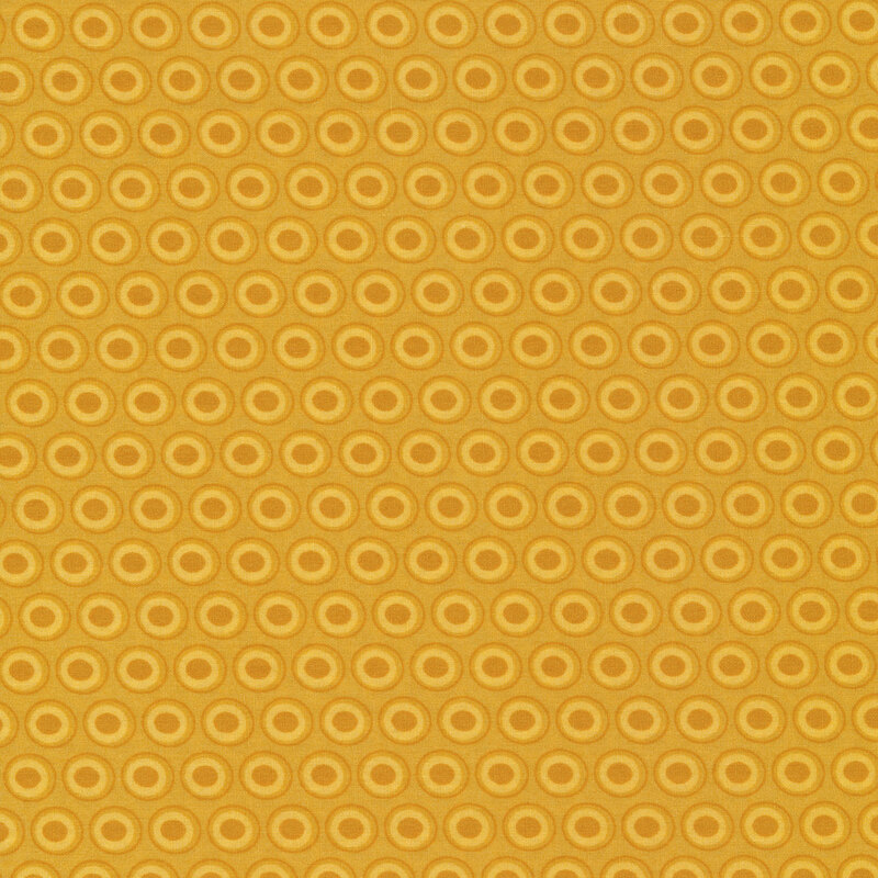 mustard fabric with a lovely pastel yellow and golden brown oval polka dot design