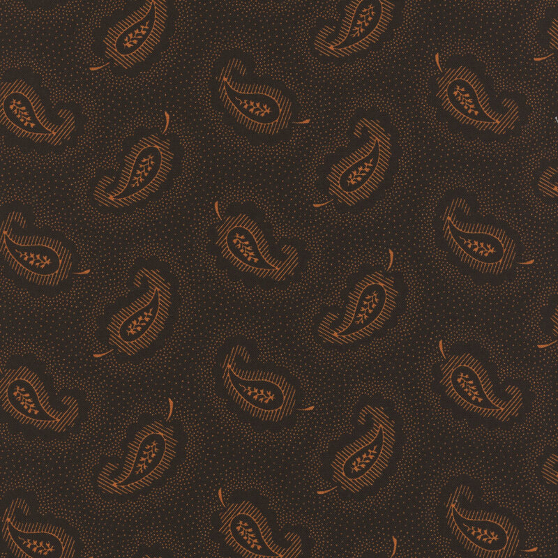 Black fabric with orange leaf-shaped paisley shapes tossed all over