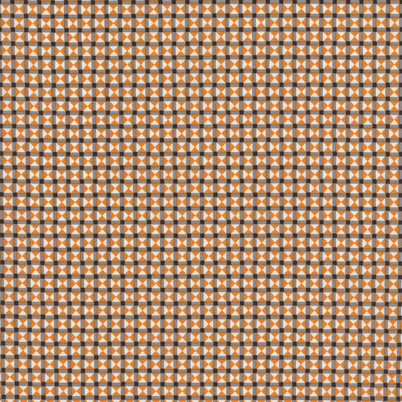 Orange, cream, black and gray fabric made up of tiny triangles in a grid-like structure