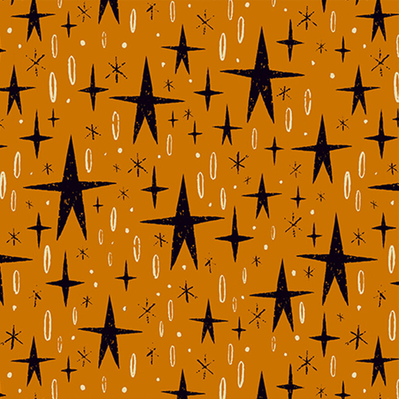 warm orange fabric, featuring stylized black stars, alongside various black and cream star motifs