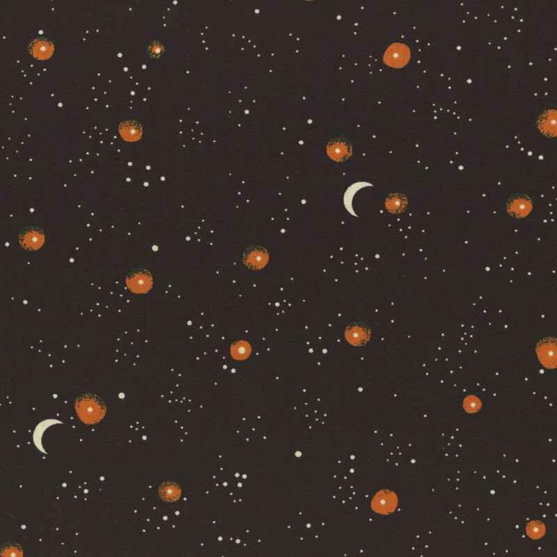 warm black fabric, featuring scattered cream and orange stars, with an occasional crescent moon