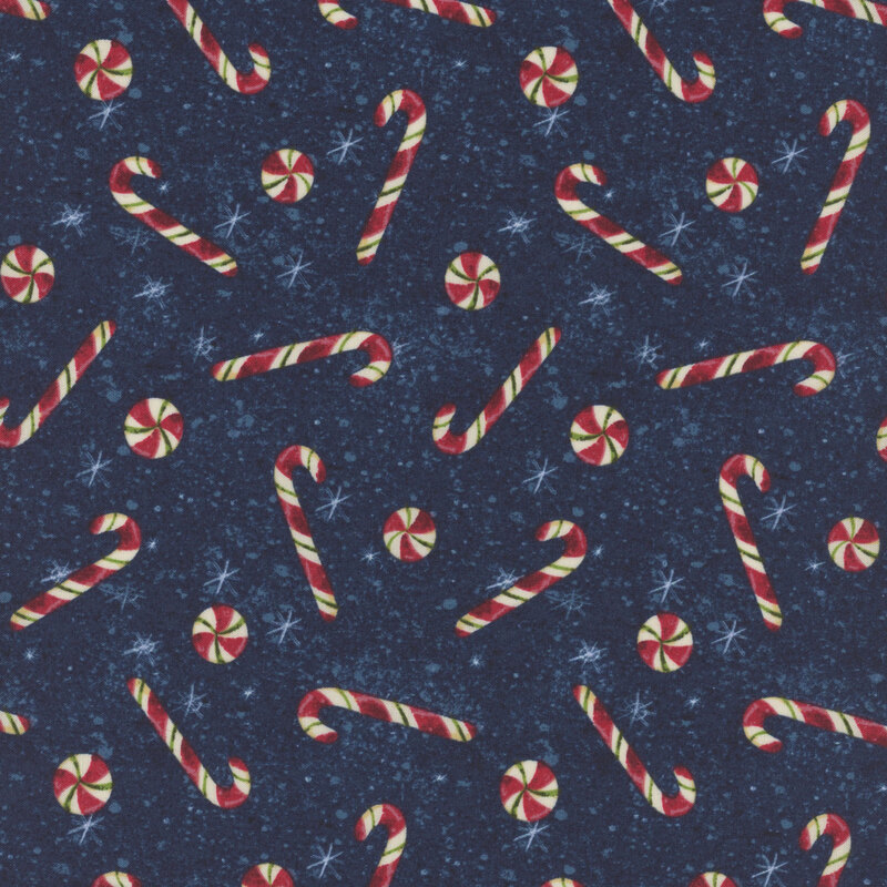 snowflake covered deep blue fabric adorned with scattered red candy canes and peppermint swirl candies