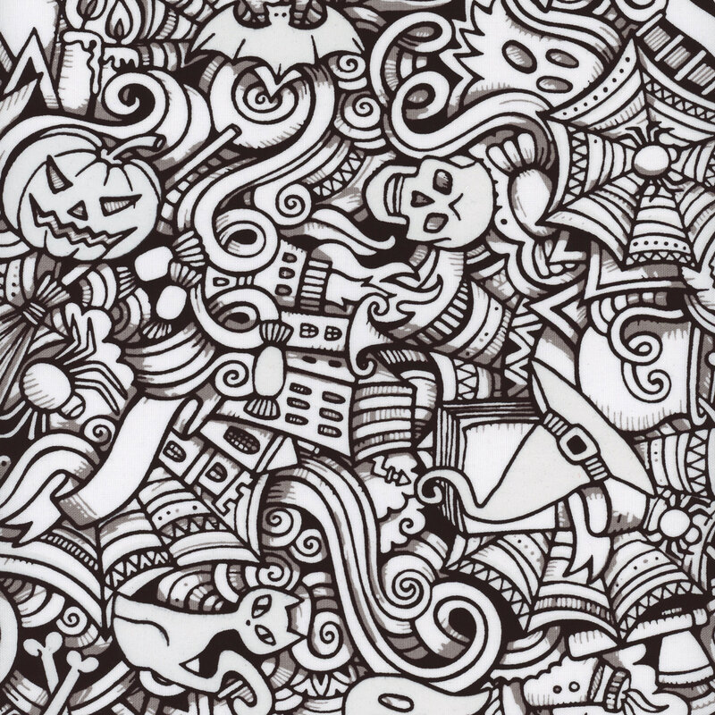 fabric featuring outlines of halloween themed objects in black and white