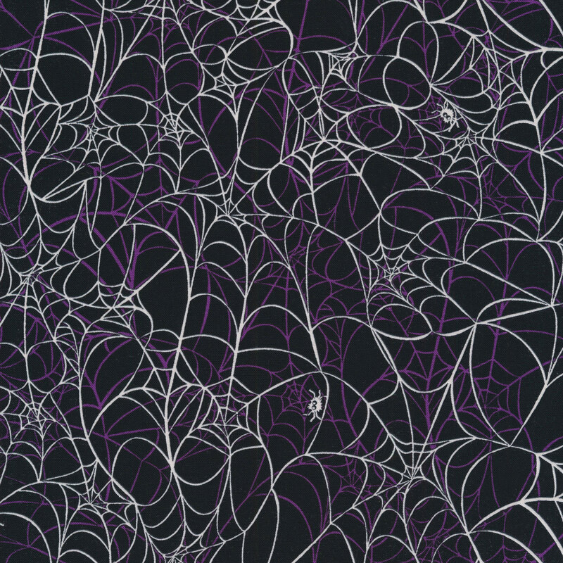 fabric featuring white and purple spider webs on a black background