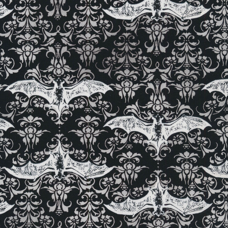 fabric featuring white bats and damask designs on a black background
