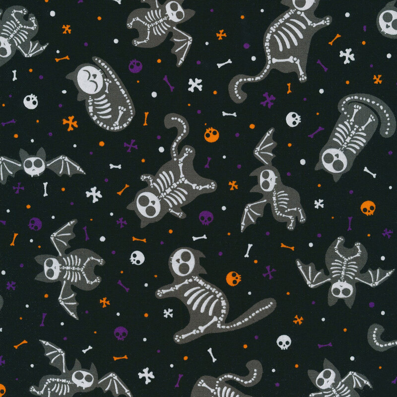 fabric featuring tossed skeletal cats and bats with tossed skulls and bones on a black background