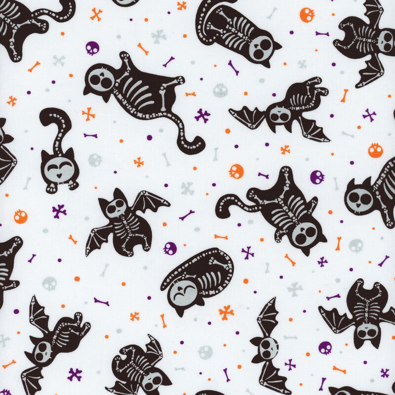 fabric featuring tossed skeletal cats and bats with tossed skulls and bones on a white background