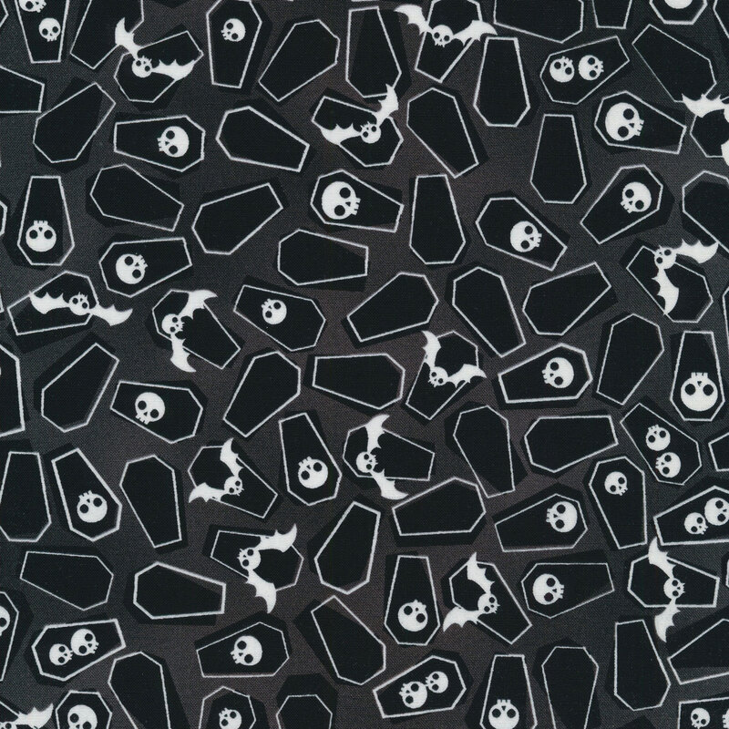 fabric featuring scattered coffins, bats and skulls on a black background