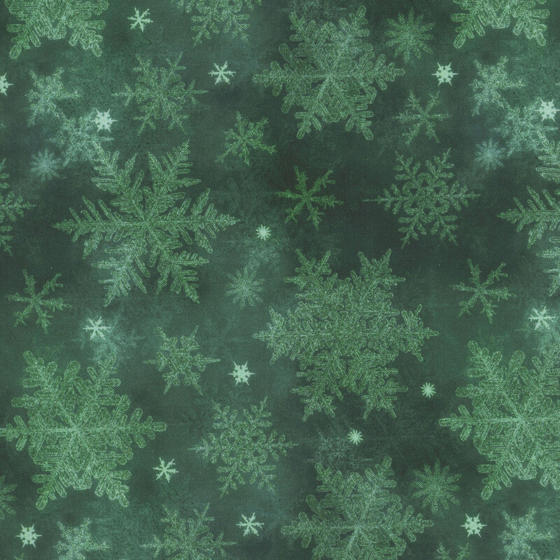 dark green mottled fabric featuring scattered tonal snowflakes