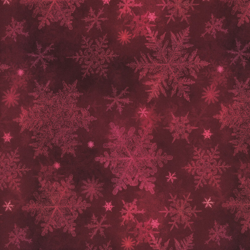 dark red mottled fabric featuring scattered tonal snowflakes