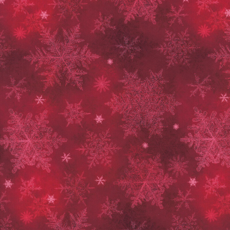 red mottled fabric featuring scattered pale snowflakes