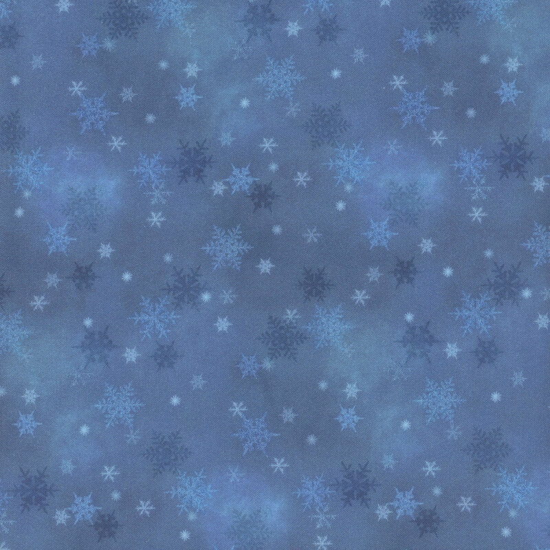 blue mottled fabric featuring small scattered tonal snowflakes