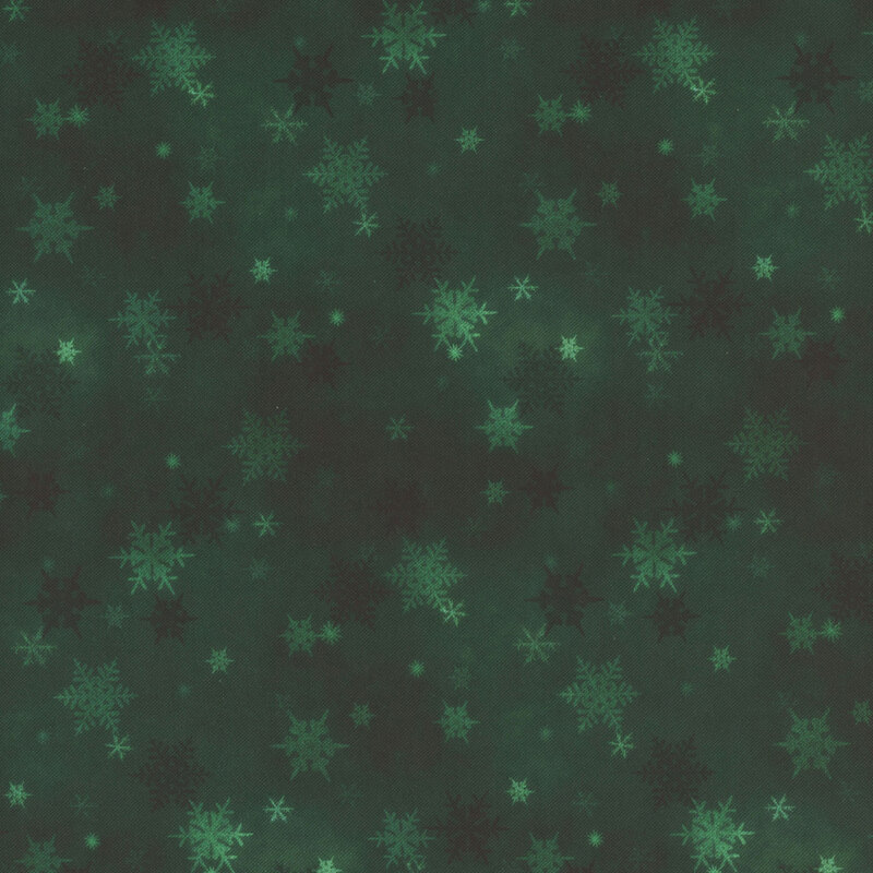 dark green mottled fabric featuring small scattered tonal snowflakes