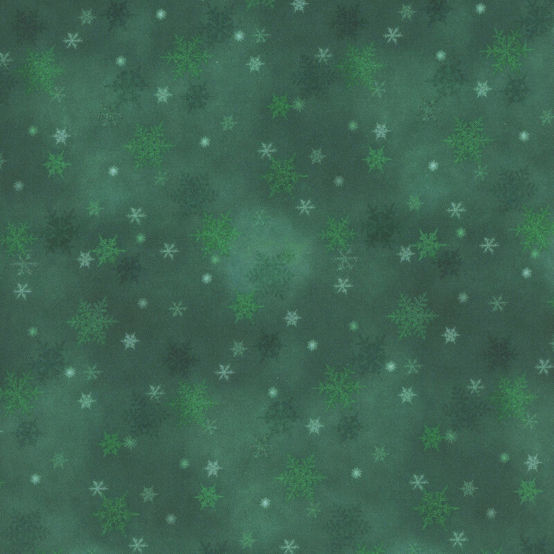 green mottled fabric featuring small scattered tonal snowflakes