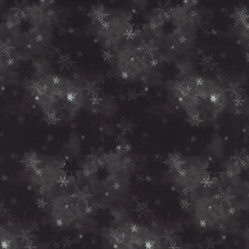 black mottled fabric featuring small scattered tonal snowflakes