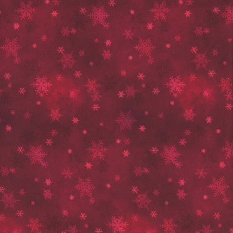 scarlet red mottled fabric featuring small scattered tonal snowflakes