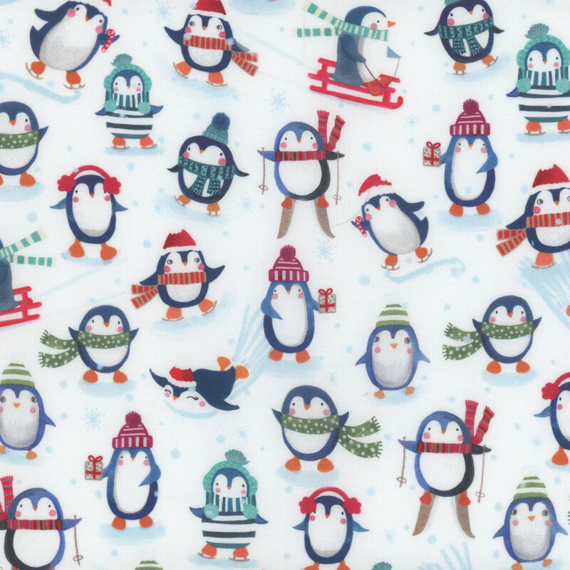 White fabric with penguins in winter outfits skiing, sledding, and skating.