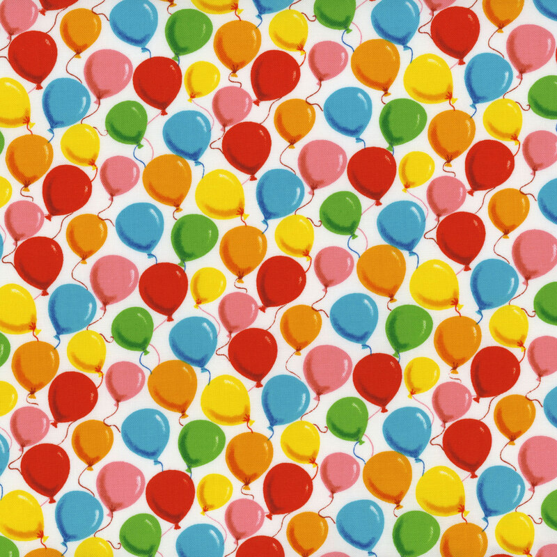 white fabric featuring a packed balloon design in shades of red, pink, orange, yellow, green, and blue