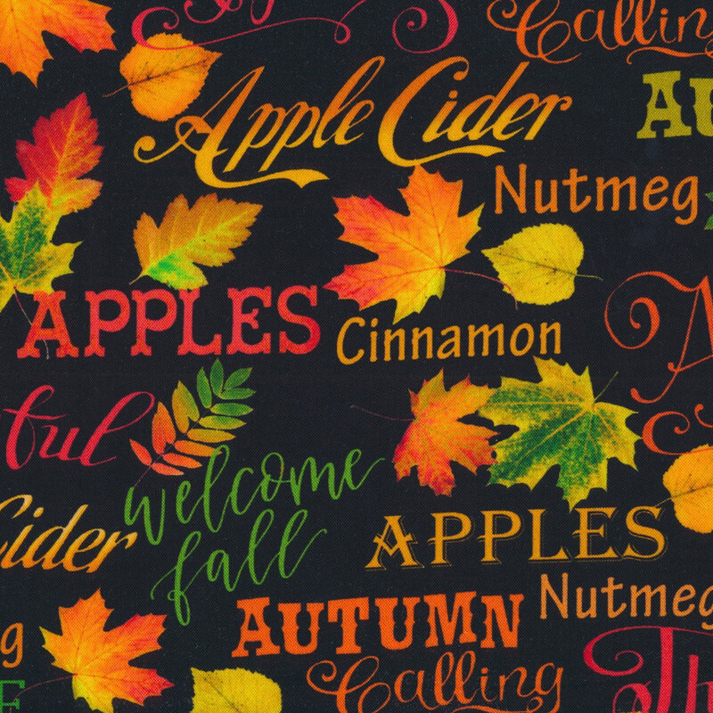 fabric featuring leaves, and autumn related sayings in red, green orange, and yellow on a black background