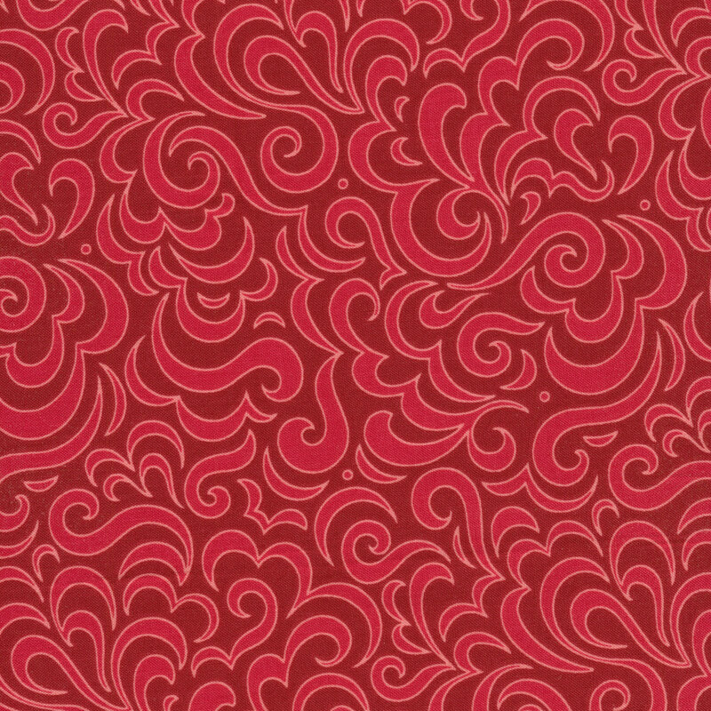 Bright red Christmas fabrics with red swirls.