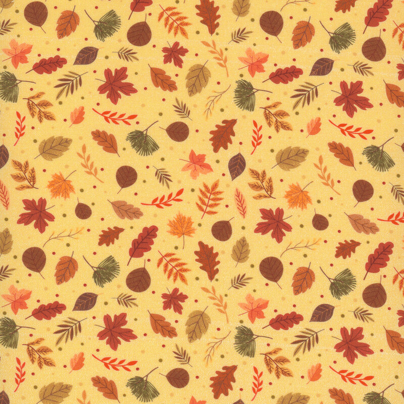 fabric featuring various green, red, brown, and orange leaves on a yellow background